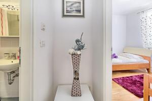 a vase with flowers on a table in a room at SUMMERTIME house with apartment in Umag +14 photos