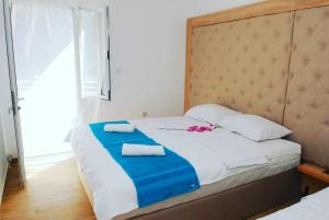 a bedroom with a bed with two towels on it at Apartments Kuc in Tivat