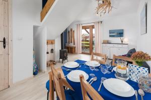 a dining room with a table with blue table cloth at Domki Marco Polo in Władysławowo