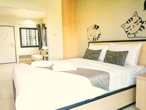Letto o letti in una camera di Sirimunta Hotel Chiang Rai Suite & Residence