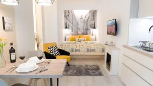 a small living room with a bed and a table at Luxury Studio 24 in Győr