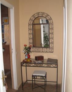 a dressing table with a mirror and a stool at Dar Loulema in Essaouira