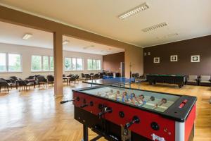 a large room with a pool table with people in it at OW Fala 1 in Łazy