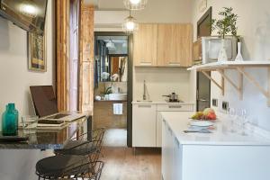 a kitchen with a counter with a bowl of fruit on it at AinB Gothic-Jaume I Apartments in Barcelona