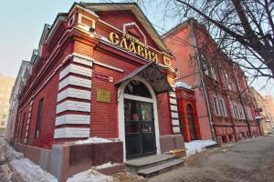 a red brick building with a sign on it at Hotel Slavia in Nizhny Novgorod