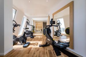 a gym with tread machines and a mirror at Seeko'o Hotel Bordeaux in Bordeaux