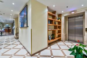 a hallway with a door and a tiled floor at My City Hotel in Tallinn