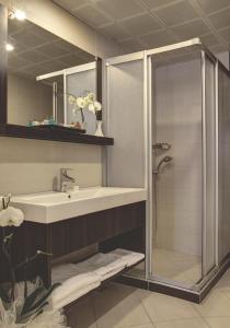 a bathroom with a sink and a shower at Susuzlu Atlantis Hotel in İzmir