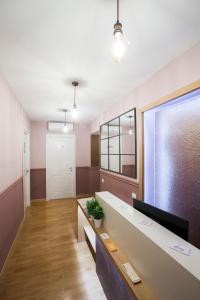 a waiting room with a desk and a window at DEM Hotel in Rome