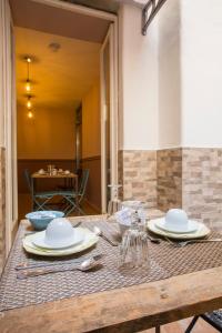 a wooden table with plates and dishes on it at DEM Hotel in Rome