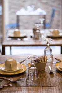 a wooden table with plates and utensils on it at DEM Hotel in Rome