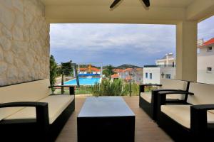 a view from the balcony of a house with a pool at Villa Summer Dreams Apartments in Murter
