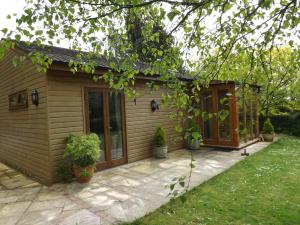 a small house with a patio in the yard at Willow Cottage in Bognor Regis