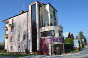 a building on the corner of a street at Dormed Medical SPA in Busko-Zdrój