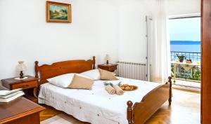 a bedroom with a bed with a view of the ocean at Apartmani AMI in Podstrana