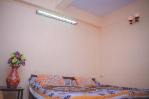 A bed or beds in a room at Prabhukrupa Tourist Farm