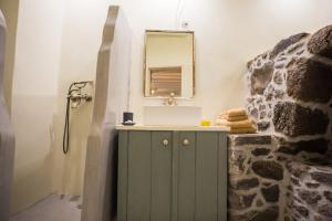a bathroom with a sink and a sink at Pyrgos Stone House in Emporeiós