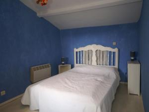 シス・フール・レ・プラージュにあるHoliday Home in Six Fours Les Plages with Terraceの白いベッドと青い壁が備わるベッドルーム1室が備わります。