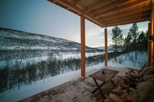 a porch with a view of a snow covered mountain at Lomatärppi in Utsjoki