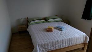 a bedroom with a bed with two towels on it at Pansion Ivanka Barac in Međugorje