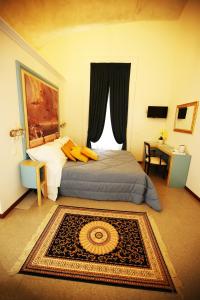 a bedroom with a bed and a window with a rug at La Bella Napoli B&B in Naples