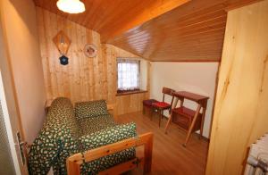 a room with a couch and a table in a house at Casa Katia in Canale dʼAgordo