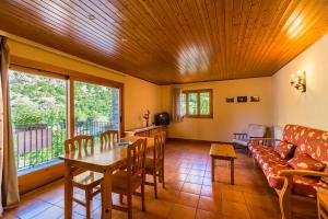 a living room with a table and a couch at Apartaments La Canal in Alins