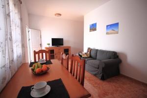 a living room with a table and a couch at MONTAÑA VALLES DE ORTEGA -C in Valles de Ortega