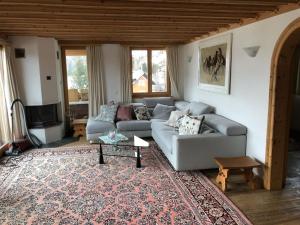 a living room with a couch and a table at Chesa il Rifugio 1 in St. Moritz