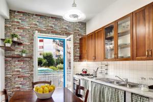 a kitchen with a table with a bowl of fruit on it at Caruso 4 in Sorrento