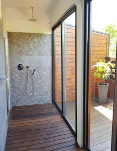 a glass door leading to a shower in a bathroom at Villa Riva in Baie-Mahault