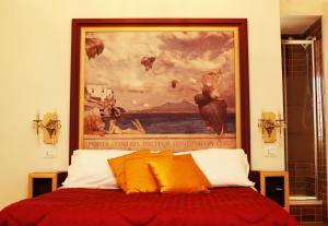 a painting on the wall above a bed in a room at La Bella Napoli B&B in Naples