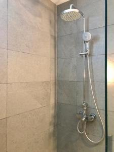 a shower with a shower head in a bathroom at Araliya OceanFront Condos Nilaveli, Trincomalee in Nilaveli