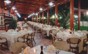 a banquet hall with white tables and chairs and lights at Agriturismo Terre Delle Monache in Pontecagnano