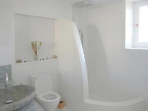 a white bathroom with a sink and a toilet at Greek paradise Spetses in Spetses