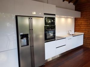 a kitchen with a stainless steel refrigerator and a sink at Villa Riva in Baie-Mahault