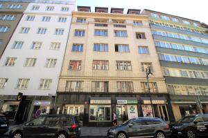 a tall building with cars parked in front of it at Agnes - Romance in city II. in Prague
