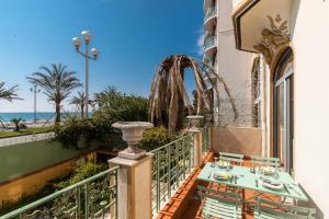 a balcony with a table and a view of the beach at Villa COLLIN - Promenade des Anglais in Nice