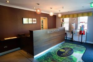 a reception area of a hotel with a reception desk at The Avenue Hotel Ltd in Clitheroe