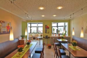 a restaurant with tables and chairs in a room at Hotel Haus am Berg in Trier