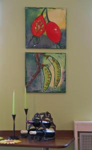 a table with glasses and two paintings on the wall at Hotel Haus am Berg in Trier +18 photos