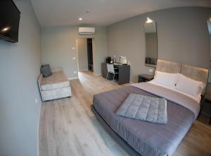 1 dormitorio con 1 cama grande y escritorio en Aurora ApartHotel en Peschiera del Garda