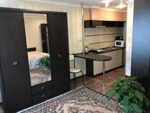 a small kitchen with a table and a bedroom at Villa L'vovskaia in Truskavets