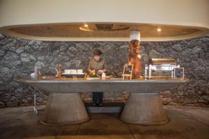a man standing at a table in a room at Nayara Hangaroa in Hanga Roa
