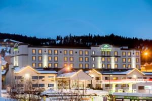 a hotel in the snow at night at Wingate by Wyndham Kamloops in Kamloops