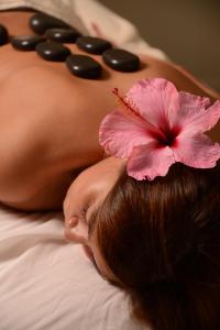 a pregnant woman with a flower on her stomach at Nayara Hangaroa in Hanga Roa