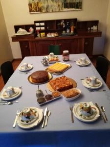 a table with a blue table cloth with food on it at 3 Tesori B&B in Castel dʼArio