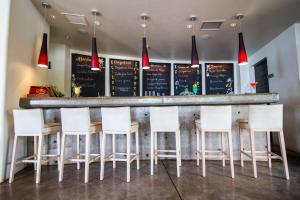 a bar with white stools in a restaurant at Nayara Hangaroa in Hanga Roa