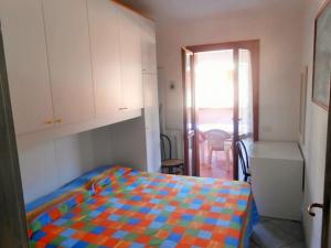 a bedroom with a bed with a colorful blanket at Casa Relax in Villasimius