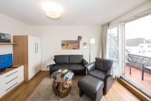 a living room with a couch and a table at Haus Wattenblick in Cuxhaven